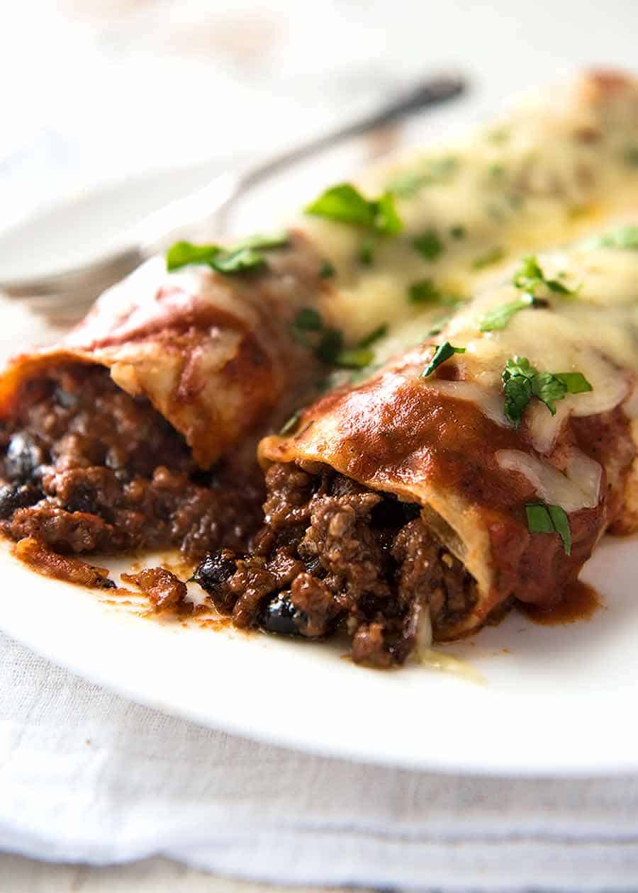 Close up of Beef and Bean Enchiladas on a plate, ready to be eaten