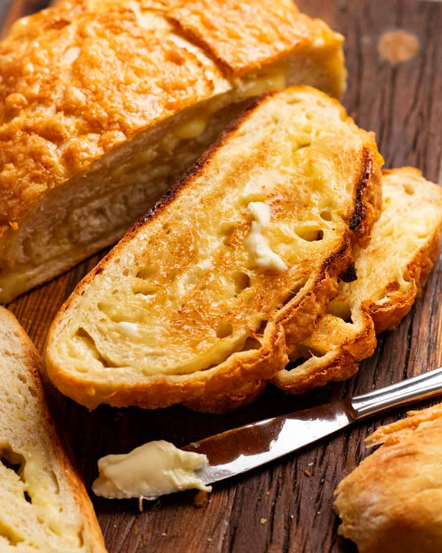 Toasted No Knead Cheese Bread slathered with butter