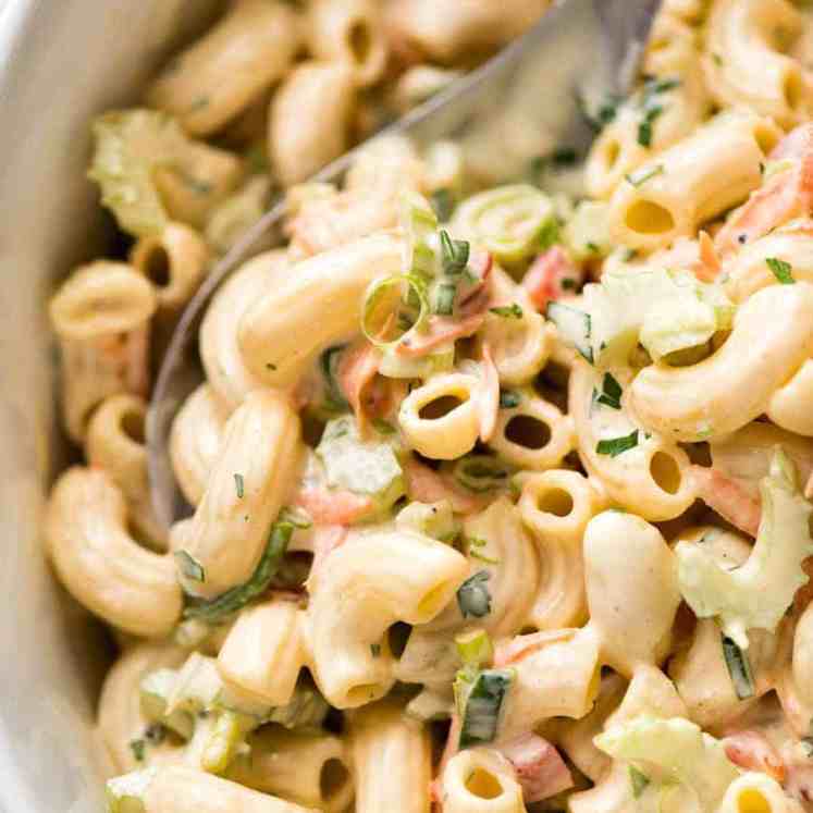Close up of Macaroni Salad with Creamy Dressing in a white bowl.