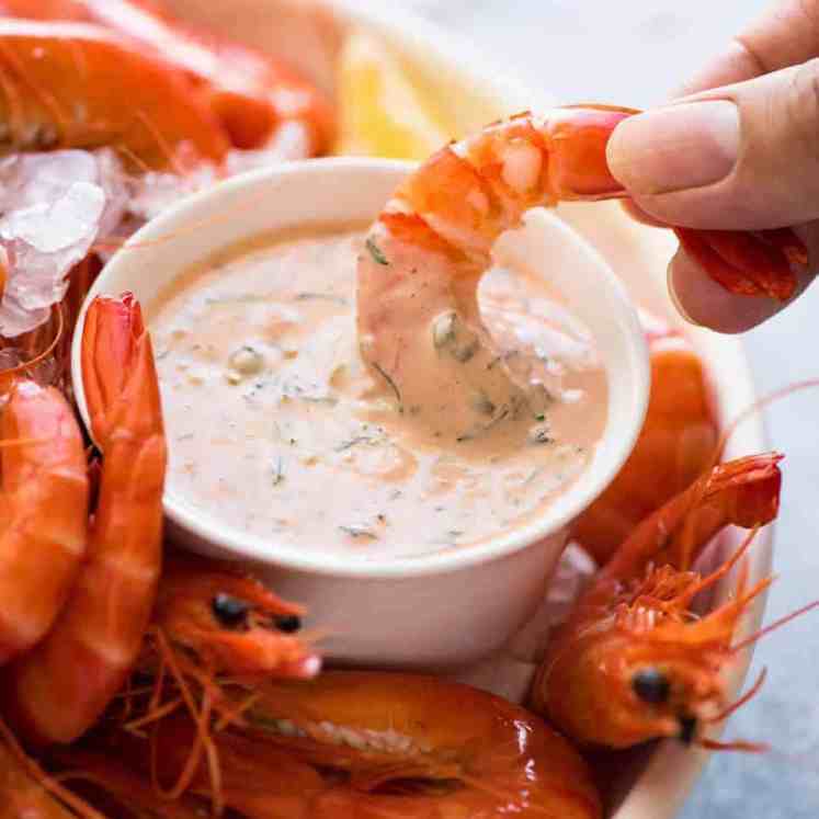 Prawn being dipped into Seafood Sauce